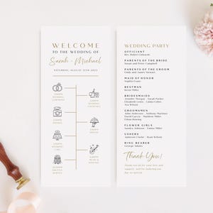 May include: A wedding program with gold text and illustrations on a white background. The program includes the names "Sarah & Michael", wedding party details, and a timeline of events. A wooden stamp and pink ribbon are in the image.
