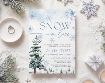 Könnte beinhalten: Eine rechteckige Einladungskarte für eine Brautparty mit dem Text SNOW in love, Olivia Frost und Veranstaltungsdetails. Das Design zeigt blaue Aquarell-Schneeflocken und eine detaillierte Illustration eines verschneiten Tannenbaums.