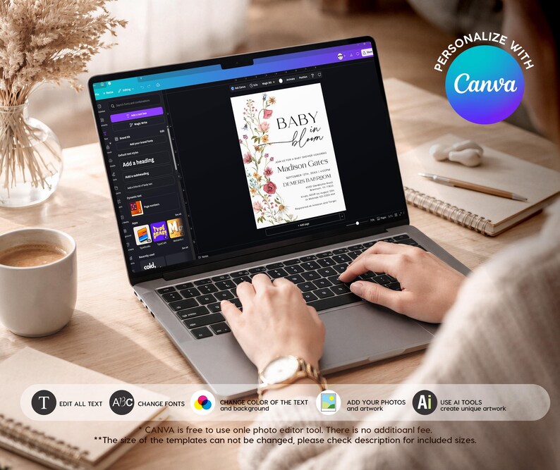 May include: A laptop screen showing a baby shower invitation design with floral elements and the words "BABY in bloom." The image includes editing tools and the Canva logo. A coffee cup, notepad, and pen are also in view.