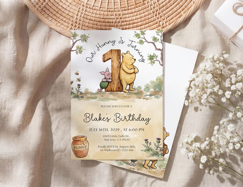 Watercolor illustration of a classic Winnie the Pooh and Piglet standing by a large wooden number one, featuring a honey pot, bees, and thistles on a soft yellow wash background.
