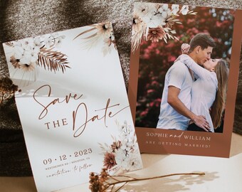 May include: Two wedding announcement cards. One card says "Save the Date" with the date 09.12.2023 and location. The other card has a photo of a couple kissing and the text "Sophie and William are getting married!" Floral accents.
