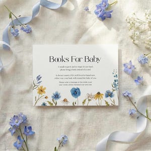 Minimalist white card with "Books For Baby" header and small wildflower meadow illustration at the bottom.
