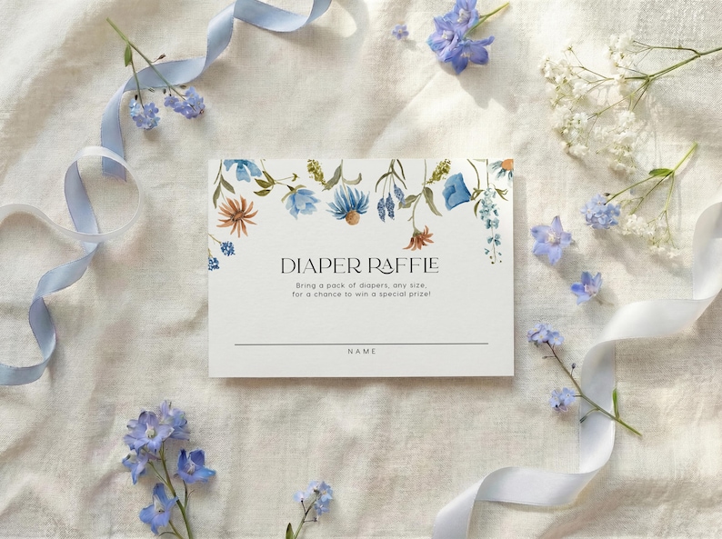 Matching white card featuring a hanging floral garland of blue and yellow wildflowers with "Diaper Raffle" text in the center.