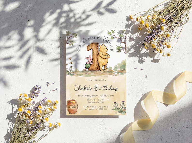 Watercolor illustration of a classic Winnie the Pooh and Piglet standing by a large wooden number one, featuring a honey pot, bees, and thistles on a soft yellow wash background.