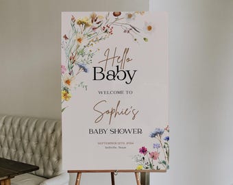 May include: A white welcome sign with a floral border and the text "Hello Baby, Welcome to Sophie's Baby Shower, September 12th, 2024, Bellville, Texas".