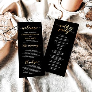 May include: Two black wedding programs with gold lettering. The left program reads "welcome" and lists the wedding details. The right program says "wedding party" and lists the wedding party members. The programs are on a cream-colored surface.