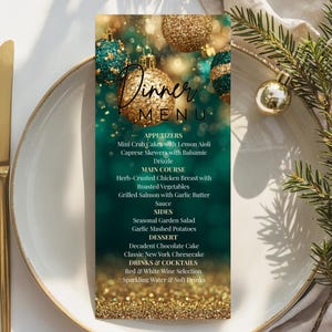 May include: A festive dinner menu card with a teal and gold color scheme, featuring gold and teal ornaments. The menu includes appetizers, main courses, sides, dessert, and drinks. Gold silverware and a white plate are in the foreground.