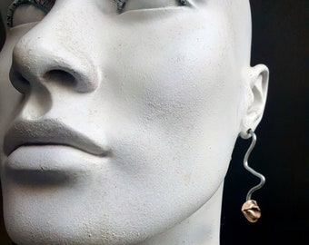 Surreal mouth and profile gauged dangly earrings,