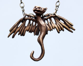 Cat necklace flying winged creature sculpture