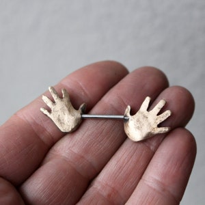 Nipple piercing jewelry. Human anatomy, hands. image 3