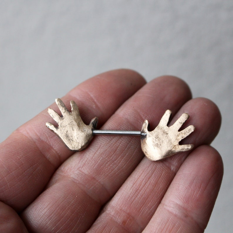 Nipple piercing jewelry. Human anatomy, hands. image 3