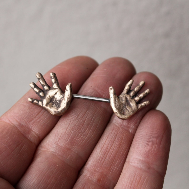 Nipple piercing jewelry. Human anatomy, hands. image 1