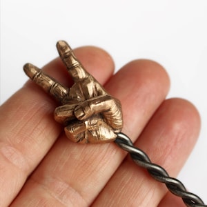 Hand making bunny ears hair stick, V is for victory