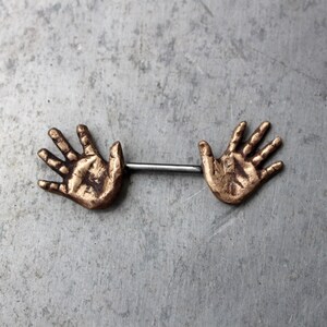 Nipple piercing jewelry. Human anatomy, hands. image 2