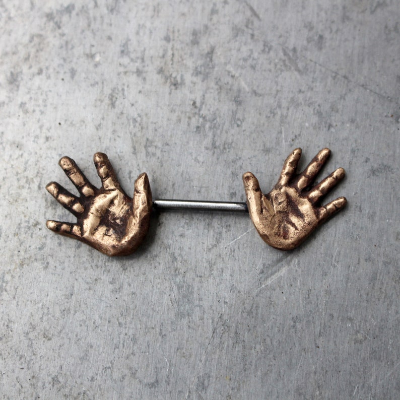 Nipple piercing jewelry. Human anatomy, hands. image 2