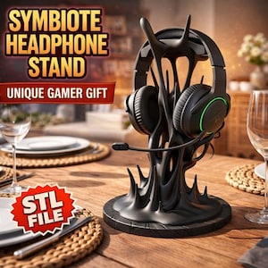 May include: A black Symbiote headphone stand with a gaming headset. The stand has a unique, organic design and holds the headset with a microphone. The text on the image reads "Symbiote Headphone Stand" and "Unique Gamer Gift".