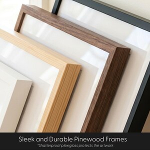 May include: A collection of four rectangular picture frames stacked diagonally, featuring white, light wood, dark wood, and black finishes. Each frame includes a white mat board and clear plexiglass. Text reads: Sleek and Durable Pinewood Frames.