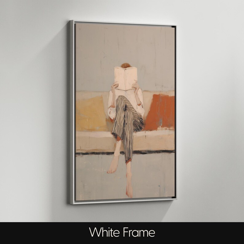 May include: Abstract artwork in a white frame. The painting shows a person reading a book while seated on a sofa. The person is wearing a white shirt and striped trousers. The sofa has yellow and orange cushions. The background is a light blue.