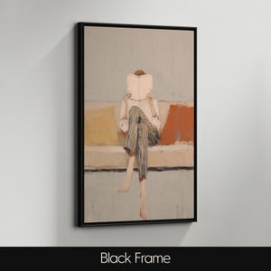 May include: An abstract painting in a black frame shows a person reading a book while seated on a sofa. The person is wearing a white shirt and striped trousers. The painting features muted tones of yellow, orange, and blue.