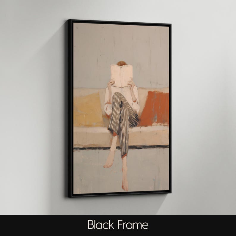 May include: An abstract painting in a black frame shows a person reading a book while seated on a sofa. The person is wearing a white shirt and striped trousers. The painting features muted tones of yellow, orange, and blue.