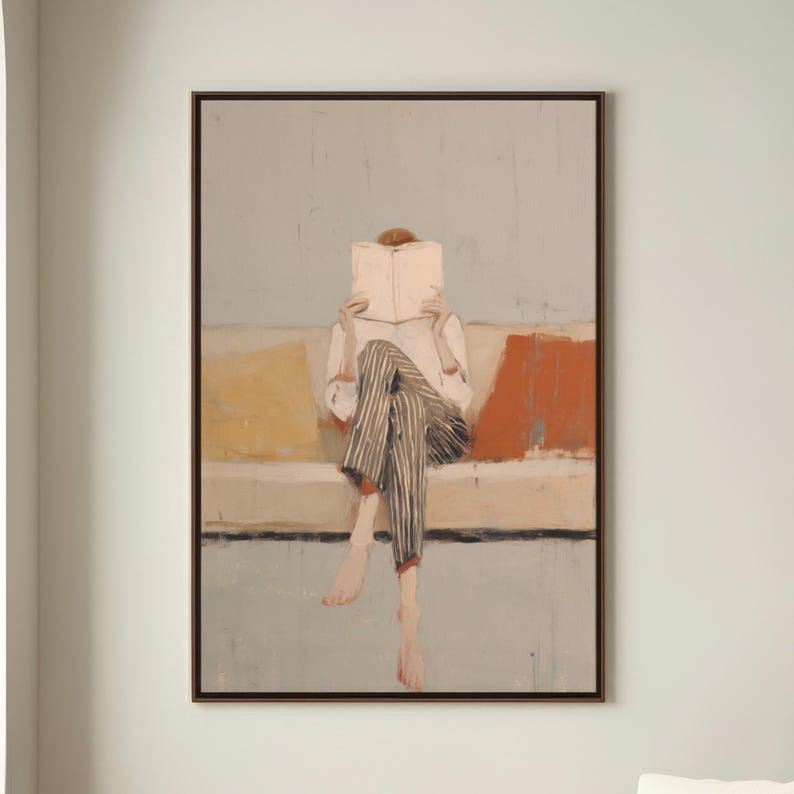 May include: An abstract painting shows a person reading a book while seated on a sofa. The person wears a white shirt and striped trousers. The sofa has yellow and orange cushions. The artwork is framed in a dark brown frame.