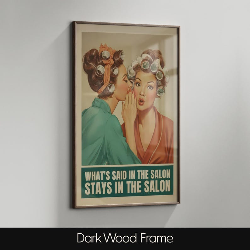 May include: Framed vintage-style print featuring two women in curlers, one whispering to the other. The print has a brown frame and the text "WHAT'S SAID IN THE SALON STAYS IN THE SALON" in a green box. The bottom of the frame reads "Dark Wood Frame".