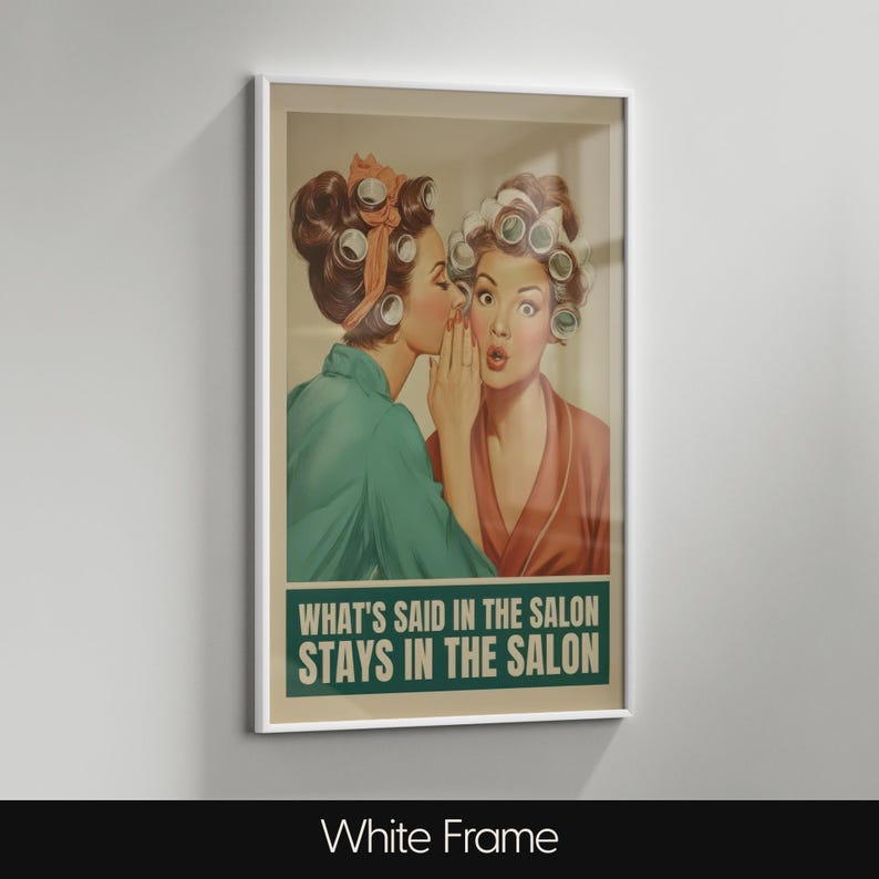 May include: A framed vintage-style print featuring two women in curlers, one whispering to the other. The print has a green banner with the text "WHAT'S SAID IN THE SALON STAYS IN THE SALON". The frame is white.