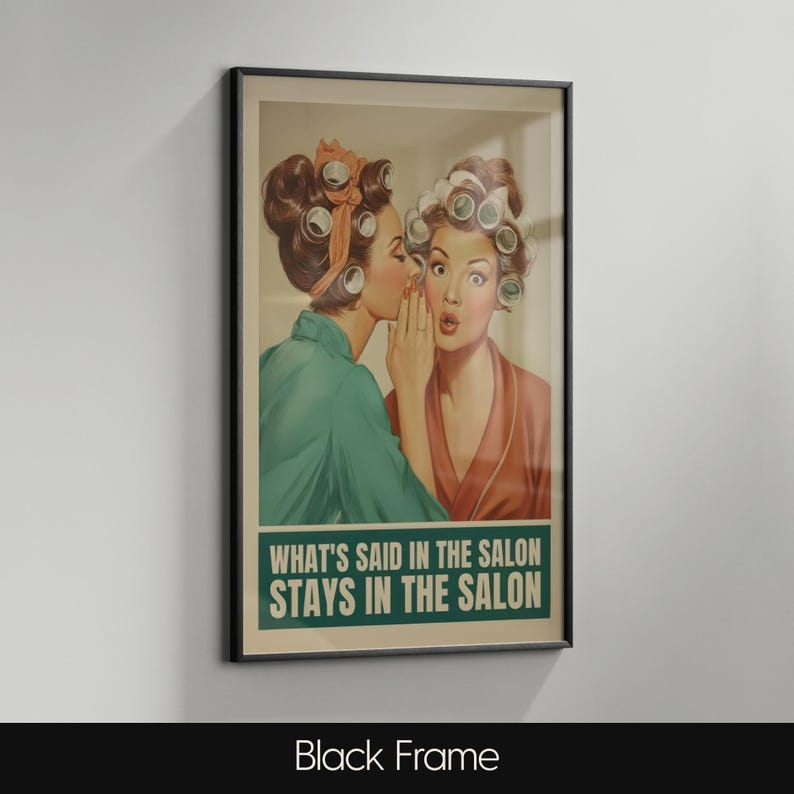 May include: Framed vintage-style print featuring two women in curlers, one whispering to the other. The print has a green and tan color scheme with the text "WHAT'S SAID IN THE SALON STAYS IN THE SALON" in a green banner. The frame is black.