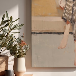 May include: Abstract canvas art featuring a figure in striped clothing and bare feet. The painting uses a muted palette of beige, grey, and yellow. A vase with dried flowers and greenery is in the foreground.