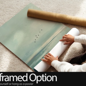 May include: A rectangular wall art poster featuring a landscape illustration of a calm sea with a sandy shoreline and a flock of birds flying in the sky. The color palette consists of muted sage green, soft blue, and beige tones.