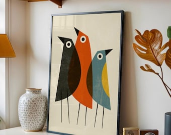 May include: A framed vertical wall art print featuring three stylized birds in black, orange, and blue with yellow accents. Each bird has a simple circular eye and thin black line legs. The background of the print is a solid off-white color.