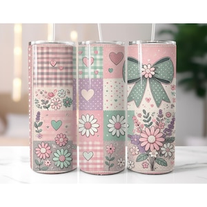 May include: Three floral-themed stainless steel tumblers with straws. Each tumbler features a different design, including patchwork patterns with hearts, daisies, and a large bow. The color palette includes pink, mint green, and lavender.