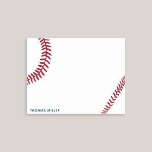 May include: A rectangular white stationery card featuring a red baseball stitch pattern along the top left and bottom right corners. The name THOMAS MILLER is printed in dark blue capital letters in the bottom left corner of the card.