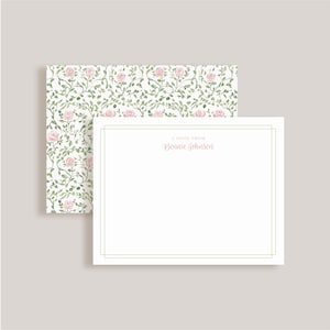 May include: A white stationery card with a double-line border and the text A NOTE FROM Bonnie Johnson in pink script. The card is layered over a matching envelope featuring a repeating watercolor pattern of pink roses and green vines.