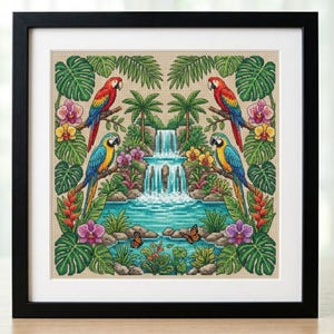 May include: Framed cross-stitch artwork featuring a tropical scene. Two pairs of colorful parrots perch on branches around a waterfall and pond. Lush green foliage, orchids, and butterflies complete the vibrant design, set against a neutral background.