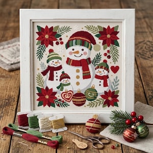 May include: A framed cross-stitch embroidery featuring a family of four snowmen surrounded by red poinsettias, green pine branches, and Christmas ornaments. The design includes red, green, and gold embroidery floss, scissors, and needles.
