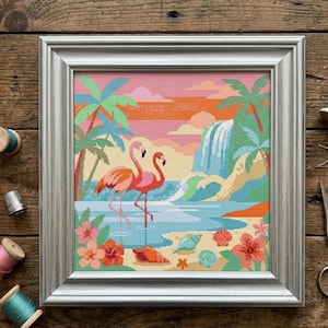 May include: Framed cross-stitch artwork featuring two pink flamingos in a tropical scene. The artwork includes palm trees, a waterfall, and seashells on a beach, all set against a colorful sunset sky. The frame is silver.