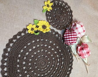 Handmade crochet placemat and coaster in brown with sunflower decoration.