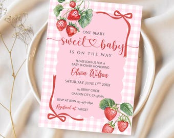 May include: A baby shower invitation with a pink gingham background and a pink scalloped border. The invitation features the text "One Berry Sweet Baby is on the Way" and includes details for the event, including the honoree's name, date, and location.