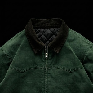May include: A dark green jacket with a corduroy collar and a black quilted lining. The jacket has a zipper closure and a classic design. The jacket is made of a durable material and is suitable for various weather conditions.