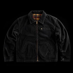 May include: A black zip-up jacket featuring a fold-down collar, long sleeves with button cuffs, and two front pockets. The interior lining displays a red, yellow, and black plaid pattern. A small zippered pocket is located on the upper left chest.