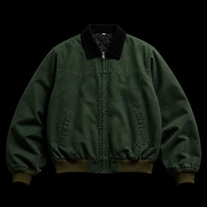 May include: A dark green jacket with a black quilted collar and a zipper closure. The jacket has two front pockets and ribbed cuffs and hem. The jacket is a bomber style.
