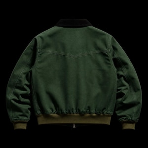 May include: A dark green bomber jacket with a black collar and a zipper closure. The jacket has a ribbed olive green hem and cuffs. The back of the jacket features a yoke detail. The jacket is made of a durable fabric.