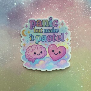 May include: A pastel pink and blue sticker with a brain and heart with smiling faces. The sticker says "panic but make it pastel".