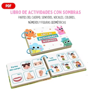 Puede incluir: Un libro de actividades infantiles en español con encuadernación en espiral. La portada muestra "Libro de Actividades Infantiles" con personajes de dibujos animados. En el interior, páginas con partes del cuerpo, sentidos y formas geométricas.