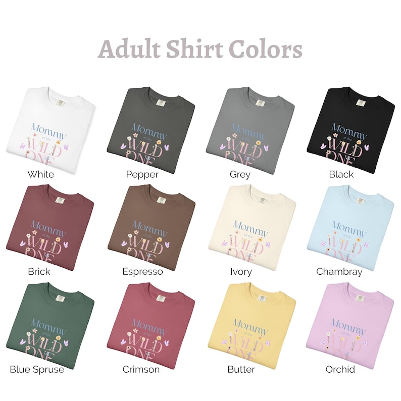 May include: A selection of adult sweatshirts in colours such as white, black, and grey. Each top features the text "Mommy of the Wild One" with floral and butterfly designs. The image is labelled "Adult Shirt Colours".