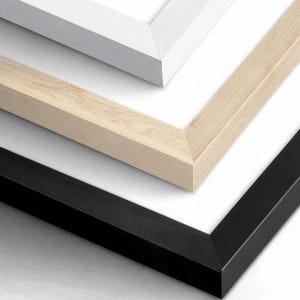 May include: A stack of three rectangular picture frames with white matting. The top frame is white, the middle frame is a light natural wood grain, and the bottom frame is black. Each frame features a clean, mitered corner design and a flat profile.