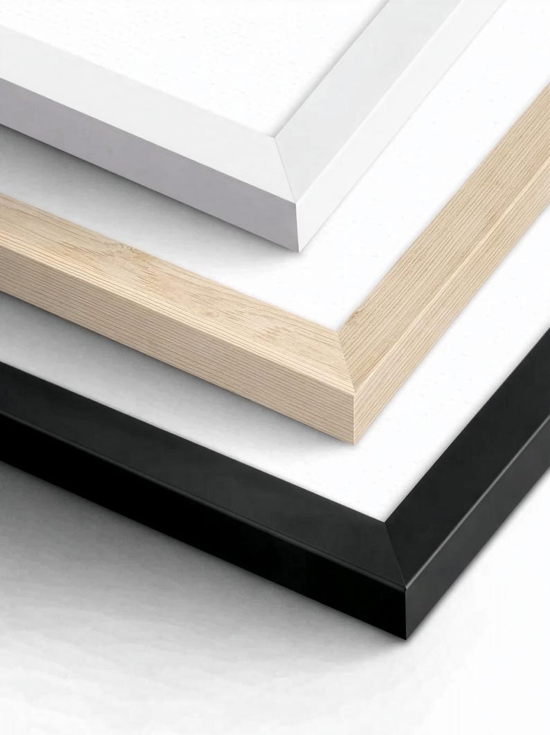 May include: A stack of three rectangular picture frames with white matting. The top frame is white, the middle frame is a light natural wood grain, and the bottom frame is black. Each frame features a clean, mitered corner design and a flat profile.
