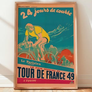 May include: Vintage poster in a wooden frame. The poster features a cyclist in yellow and blue, with text in French: "24 jours de course" and "Tour de France 49". The background is teal and orange.