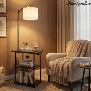 May include: A black floor lamp with a side table, featuring a beige lampshade and three-tiered shelves. The table holds books, plants, and a cup of coffee. A beige armchair with a knitted throw and a small side table with glasses complete the cozy scene.